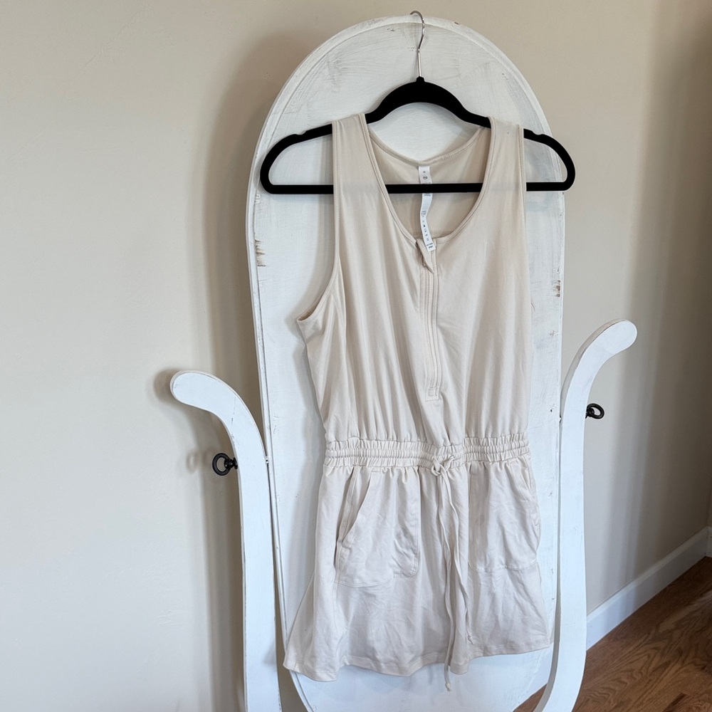 Rae Mode Sleeveless Cream Romper has one spot from a sticker on it